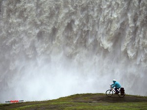 With the bike near a waterfall