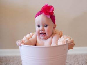 Baby bathing in a bucket