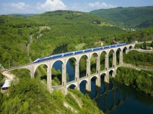 Train crossing the Cize-Bolozon viaduct (France)