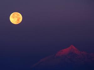 The moon illuminating the mountaintop
