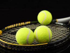 Three balls and a tennis racket