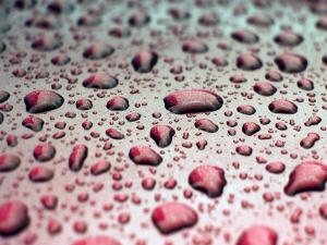 Water drops on a red surface