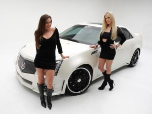 Girls next to a white sports car