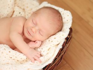 Baby sleeping in a basket