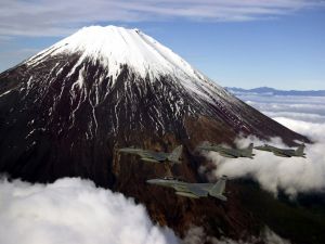 Fighter jets flying over a volcano