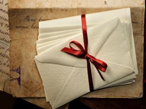 Envelopes tied with a red ribbon