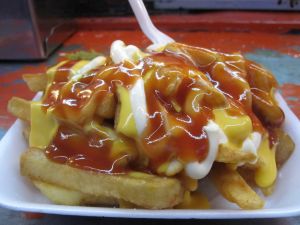 Fried potatoes with lot of sauce