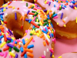 Donuts with pink glace and colored sprinkles