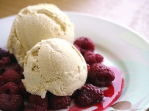 Balls of vanilla ice cream with raspberries