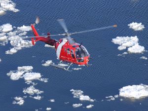 Canadian Coast Guard in a helicopter over the San Lorenzo River