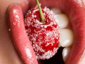 Biting a sugared cherry