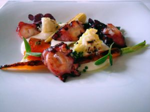 Slices of grilled octopus with vegetables