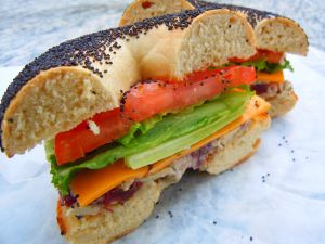 Poppy Seed Bagel with vegetables and cheddar cheese