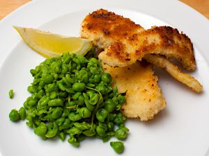 Strips of fried fish with peas
