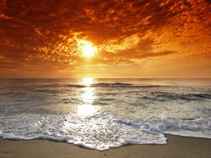 Reflection of sun on the sea shore