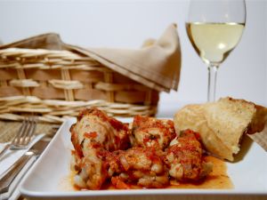 Chicken dish with a glass of white wine
