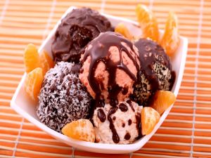 Ice cream with chocolate sauce and tangerines