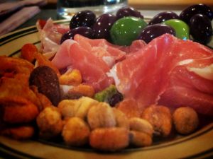 Appetizer with ham, olives and dried fruit