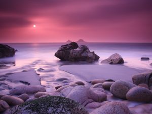Pink sunset on a rocky beach