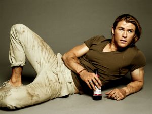 Chris Hemsworth, dirty and with a beer