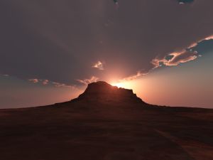 The sun behind the hill