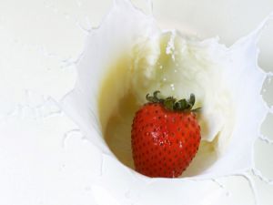 Milk and strawberry falling