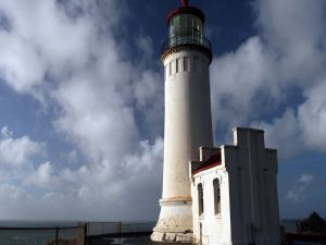 White lighthouse next to the sea