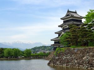 The Matsumoto Castle and snowy mountains