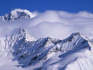 Clouds over snowy mountains