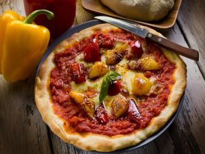 Pizza with red and yellow pepper