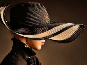 Distinguished woman with hat and earrings